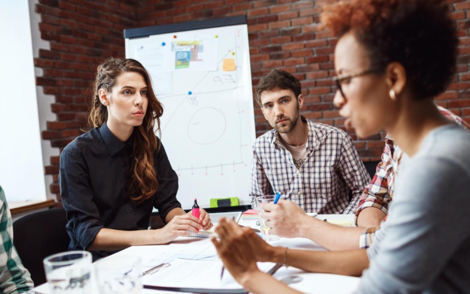 Multi-generational family discussing financial planning around dining table